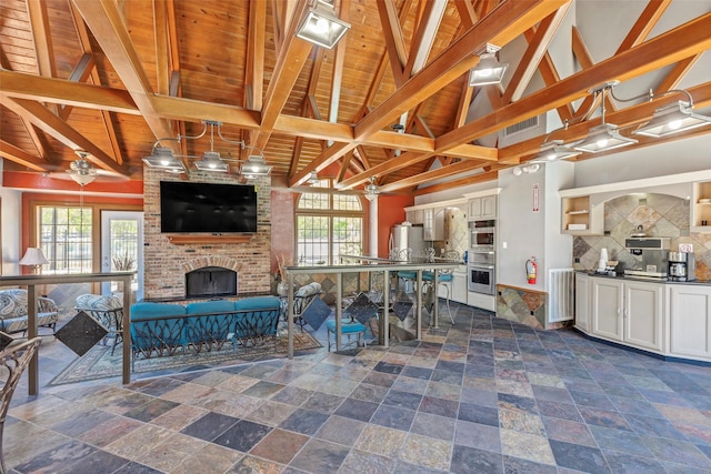 2300 Old Spanish Trl Unit 2059, Houston, TX 77054 - living area with wooden ceiling, a fireplace, and dark stone finish flooring