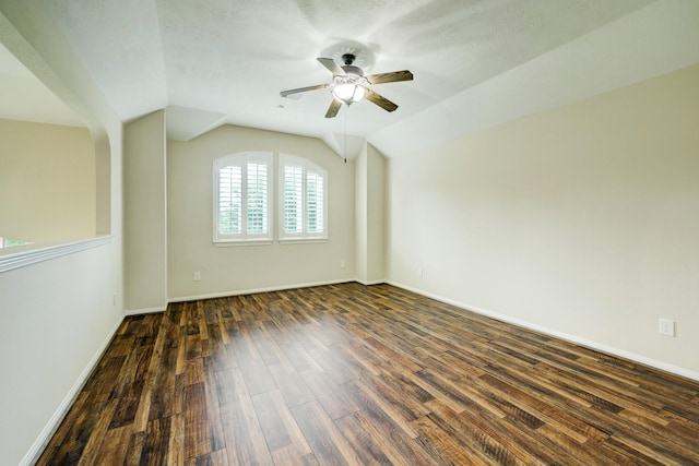 24635 Blue Opal Ln, Katy, TX 77494 - empty room with a ceiling fan, dark wood-type flooring, vaulted ceiling, and baseboards