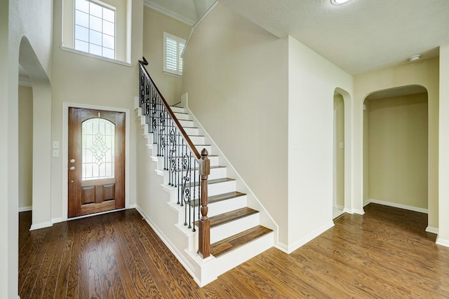 24635 Blue Opal Ln, Katy, TX 77494 - entryway featuring arched walkways, wood finished floors, stairs, and baseboards