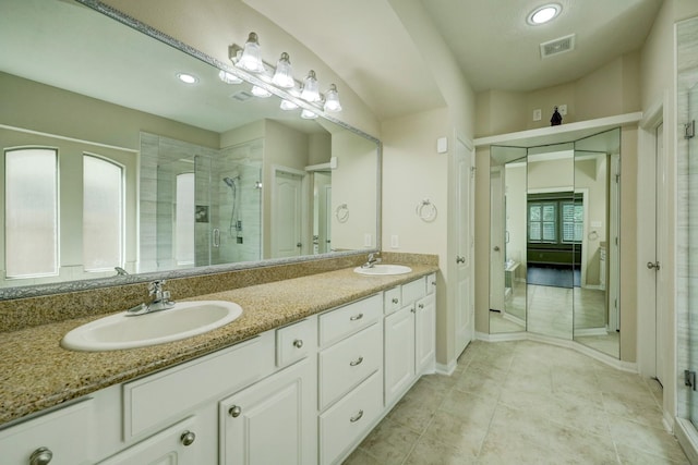 24635 Blue Opal Ln, Katy, TX 77494 - bathroom featuring double vanity, a shower stall, baseboards, recessed lighting, and tile patterned floors