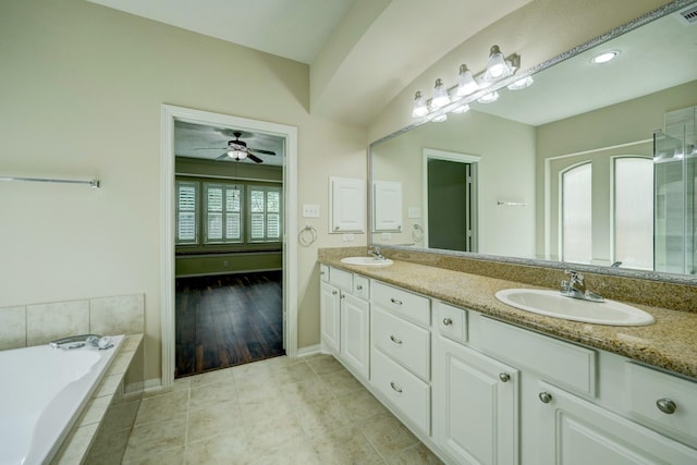 24635 Blue Opal Ln, Katy, TX 77494 - full bathroom featuring double vanity, a bath, a ceiling fan, baseboards, and tile patterned flooring