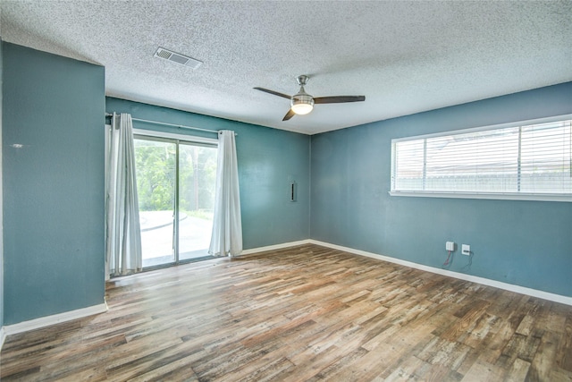 55 Willow Ct, Lake Jackson, TX 77566 - spare room featuring wood finished floors, a ceiling fan, a textured ceiling, and baseboards
