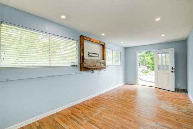 55 Willow Ct, Lake Jackson, TX 77566 - spare room with baseboards, wood finished floors, recessed lighting, and a sink