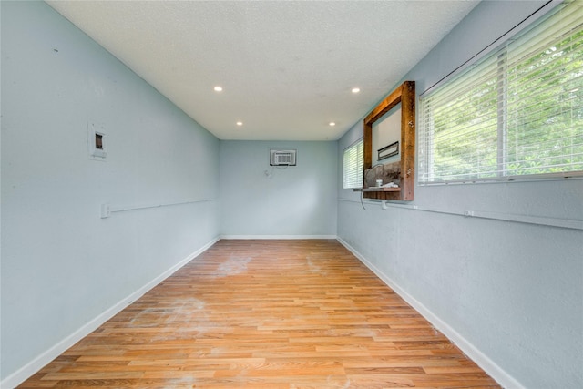 55 Willow Ct, Lake Jackson, TX 77566 - empty room featuring light wood-type flooring, baseboards, recessed lighting, and a wall mounted AC