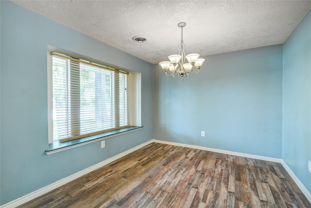55 Willow Ct, Lake Jackson, TX 77566 - empty room with a textured ceiling, a chandelier, wood finished floors, and baseboards