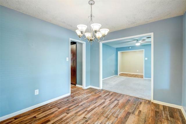 55 Willow Ct, Lake Jackson, TX 77566 - empty room with a chandelier, wood finished floors, a textured ceiling, baseboards, and a ceiling fan