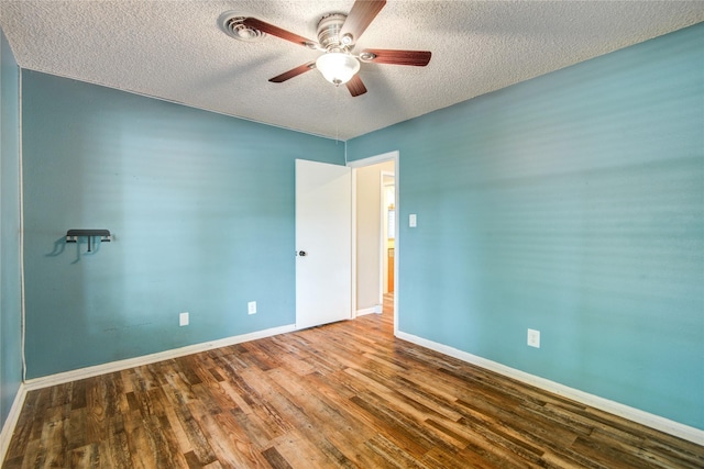 55 Willow Ct, Lake Jackson, TX 77566 - unfurnished bedroom with a textured ceiling, wood finished floors, baseboards, and ceiling fan