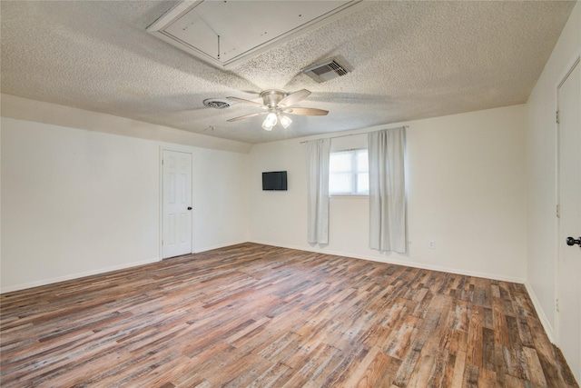 55 Willow Ct, Lake Jackson, TX 77566 - empty room featuring attic access, wood finished floors, ceiling fan, a textured ceiling, and baseboards
