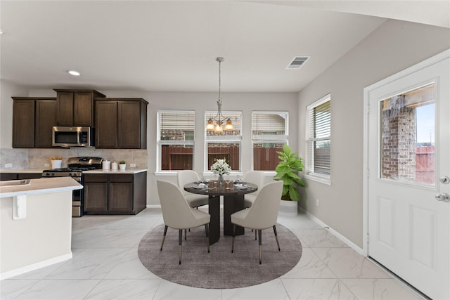 14818 Autumn Long Trl, Humble, TX 77396 - dining space with light marble finish flooring, a chandelier, recessed lighting, and baseboards