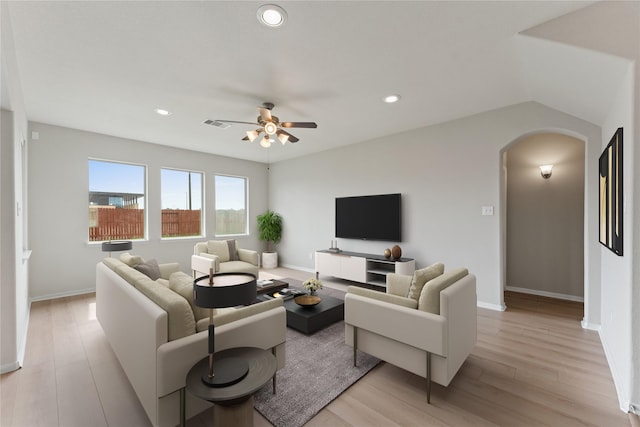 14818 Autumn Long Trl, Humble, TX 77396 - living room with arched walkways, a ceiling fan, light wood-style floors, recessed lighting, and baseboards
