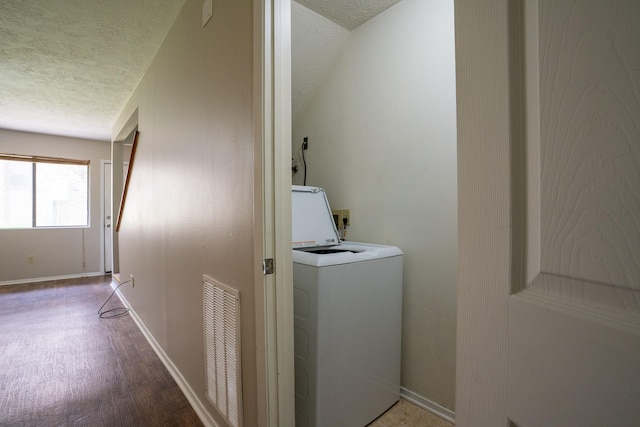 2521 Crosstimbers St Unit G3, Huntsville, TX 77320 - washroom with washer / clothes dryer, a textured ceiling, and baseboards