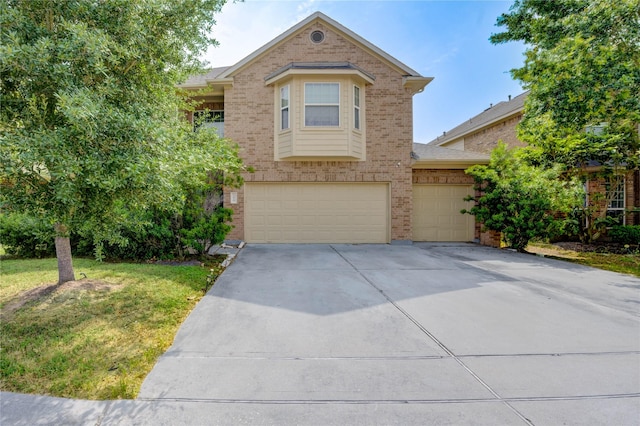 1610 Mason Knights Dr, Katy, TX 77493 - view of front of property featuring brick siding, concrete driveway, a garage, and a front yard