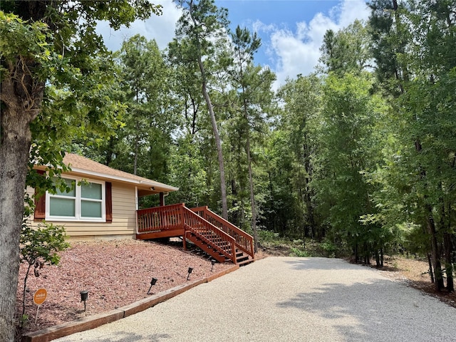 534 Oakdale Dr, Huntsville, TX 77320 - view of front of house featuring a wooden deck and roof with shingles