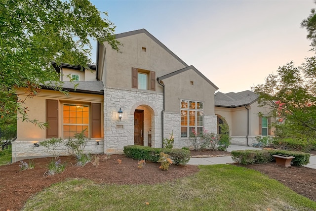 105 Checkerbloom Ct, Montgomery, TX 77316 - view of front of house featuring stone siding, stucco siding, and a front lawn