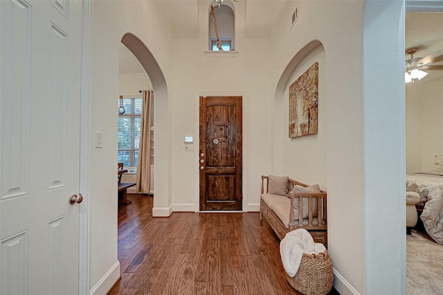 105 Checkerbloom Ct, Montgomery, TX 77316 - foyer with wood finished floors, arched walkways, ceiling fan, and baseboards