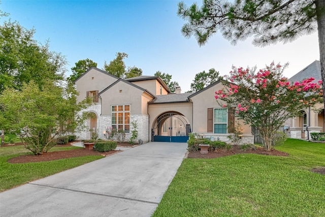 105 Checkerbloom Ct, Montgomery, TX 77316 - view of front facade with stone siding, driveway, stucco siding, a front yard, and a chimney