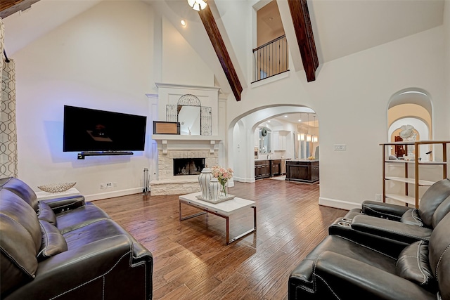 105 Checkerbloom Ct, Montgomery, TX 77316 - living area featuring high vaulted ceiling, arched walkways, baseboards, and wood finished floors