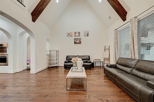 105 Checkerbloom Ct, Montgomery, TX 77316 - living room featuring high vaulted ceiling, beamed ceiling, wood finished floors, arched walkways, and baseboards