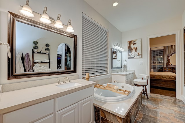 105 Checkerbloom Ct, Montgomery, TX 77316 - bathroom with ensuite bathroom, stone tile flooring, two vanities, and a bath