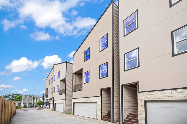 1216 E 34th St Unit B, Houston, TX 77022 - view of property featuring a garage, fence, and a residential view