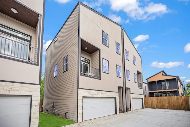 1216 E 34th St Unit B, Houston, TX 77022 - view of front facade featuring stone siding, stucco siding, an attached garage, and fence