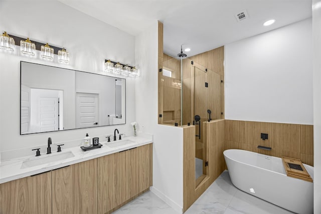 1216 E 34th St Unit B, Houston, TX 77022 - full bath with marble finish floors, a stall shower, a freestanding tub, double vanity, and a wainscoted wall