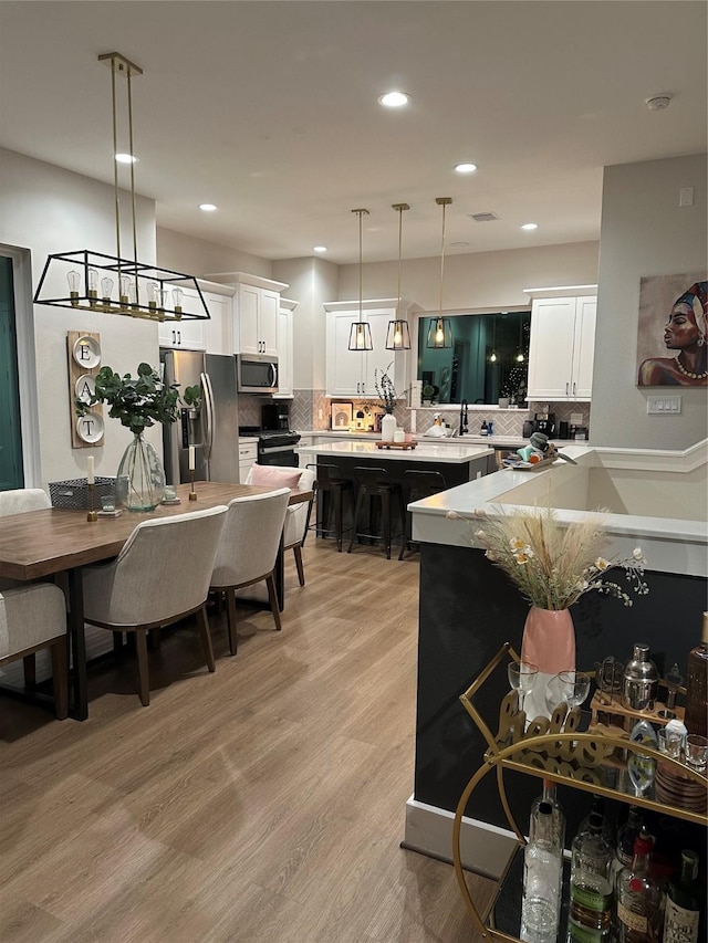 4816 Brinkman St, Houston, TX 77018 - kitchen with stainless steel appliances, light countertops, tasteful backsplash, white cabinets, and recessed lighting