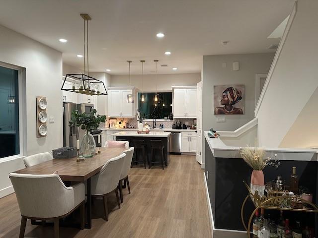 4816 Brinkman St, Houston, TX 77018 - dining space featuring light wood finished floors, recessed lighting, and a chandelier