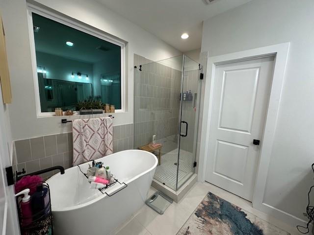 4816 Brinkman St, Houston, TX 77018 - full bath featuring a freestanding bath, a shower stall, tile patterned floors, tile walls, and recessed lighting
