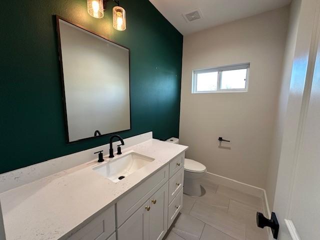 4816 Brinkman St, Houston, TX 77018 - half bathroom with vanity, toilet, tile patterned floors, and baseboards