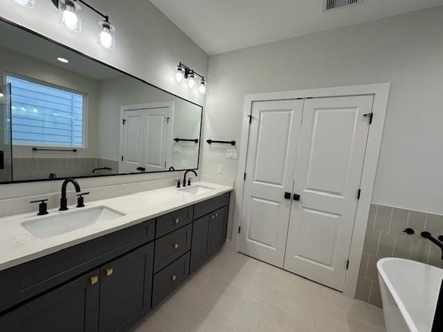 4816 Brinkman St, Houston, TX 77018 - full bath with a freestanding bath, double vanity, and tile patterned floors