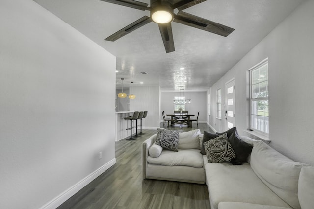 3508 Dick Barnes Loop, Bedias, TX 77831 - living room featuring wood finished floors, a chandelier, baseboards, and a ceiling fan