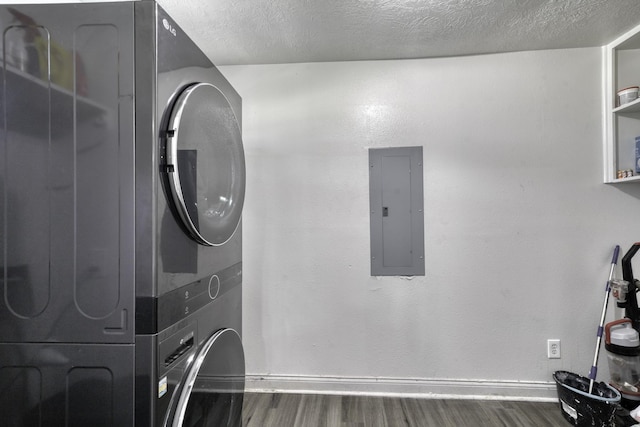 3508 Dick Barnes Loop, Bedias, TX 77831 - washroom with electric panel, stacked washer and clothes dryer, wood finished floors, baseboards, and a textured ceiling