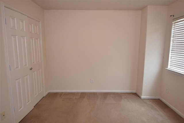 21031 Noelle Ct, Humble, TX 77338 - unfurnished bedroom with light colored carpet, baseboards, and a closet