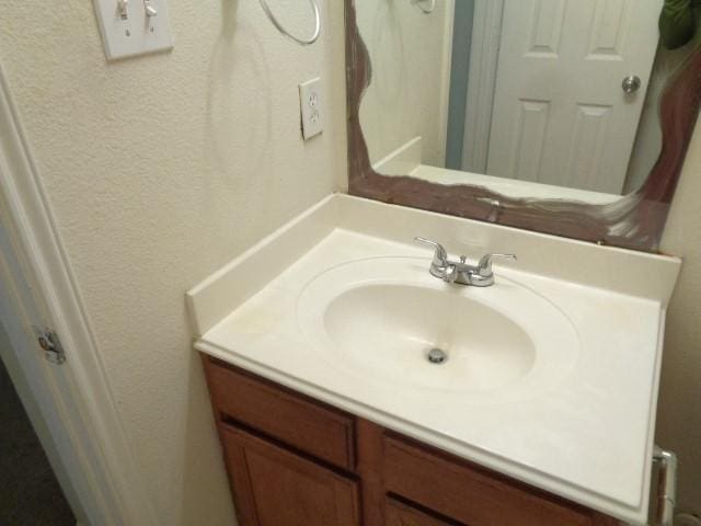 21031 Noelle Ct, Humble, TX 77338 - bathroom featuring vanity and a textured wall
