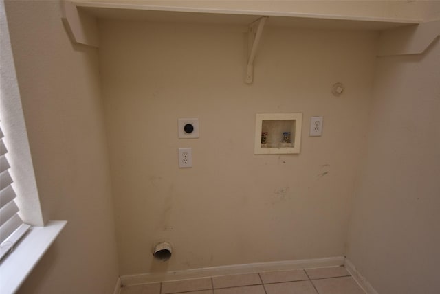 21031 Noelle Ct, Humble, TX 77338 - washroom with hookup for a gas dryer, electric dryer hookup, light tile patterned floors, hookup for a washing machine, and baseboards