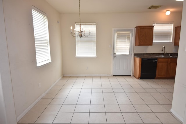 21031 Noelle Ct, Humble, TX 77338 - kitchen with black dishwasher, a sink, a chandelier, dark countertops, and brown cabinetry
