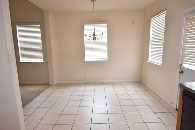 21031 Noelle Ct, Humble, TX 77338 - unfurnished dining area featuring a chandelier, plenty of natural light, and baseboards