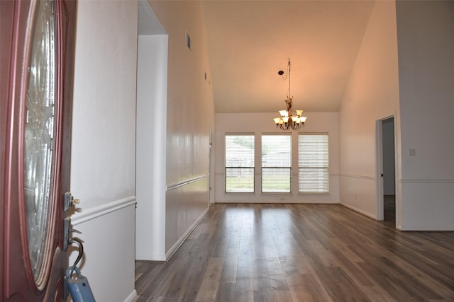 entrance foyer featuring a chandelier, high vaulted ceiling, baseboards, and wood finished floors