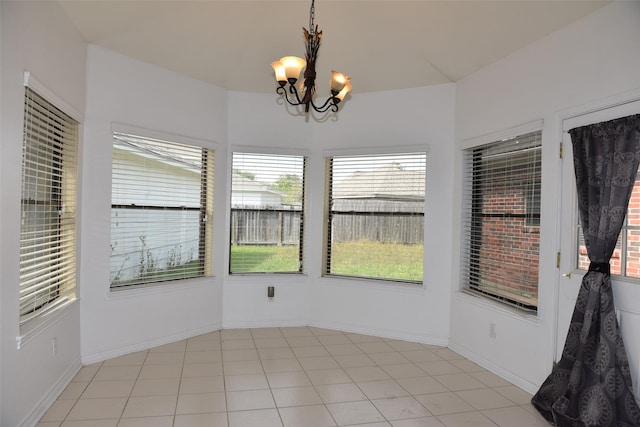 unfurnished sunroom with healthy amount of natural light and a chandelier