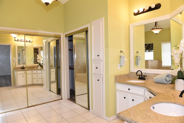 full bath featuring tile patterned flooring, double vanity, and a towering ceiling