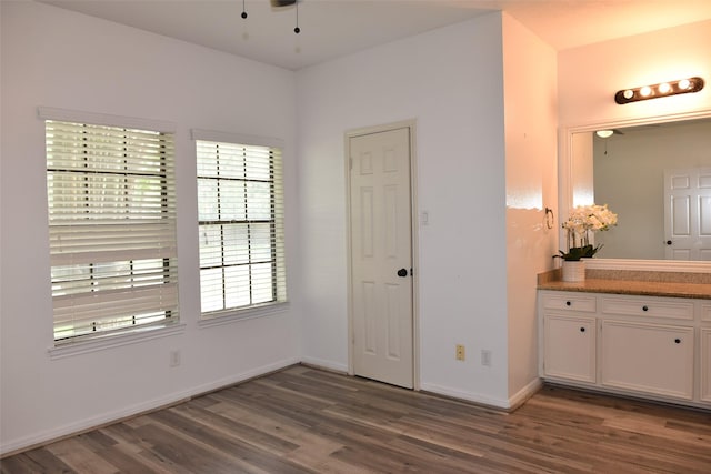 unfurnished bedroom featuring wood finished floors and baseboards