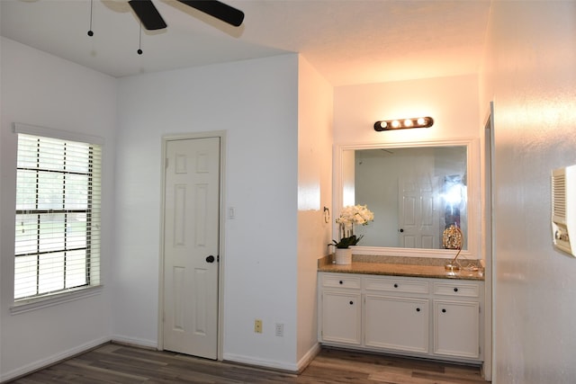bathroom featuring wood finished floors, a ceiling fan, vanity, and baseboards