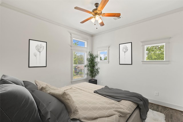 1202 Archer St, Houston, TX 77009 - bedroom featuring wood finished floors, multiple windows, ornamental molding, baseboards, and a ceiling fan