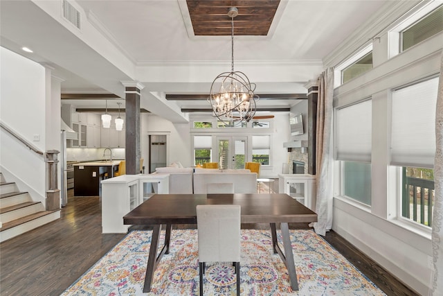 1202 Archer St, Houston, TX 77009 - dining area with a chandelier, dark wood finished floors, and stairs