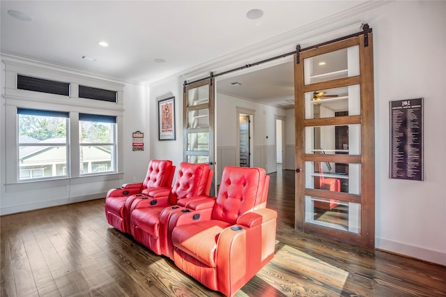 1202 Archer St, Houston, TX 77009 - home theater with a barn door, ornamental molding, wood finished floors, baseboards, and recessed lighting