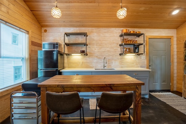 1202 Archer St, Houston, TX 77009 - kitchen with a sink, open shelves, plenty of natural light, wood walls, and freestanding refrigerator
