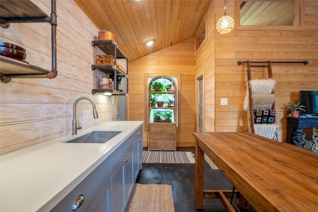 1202 Archer St, Houston, TX 77009 - kitchen featuring a sink, lofted ceiling, light countertops, wood walls, and wooden ceiling
