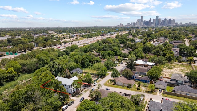 1202 Archer St, Houston, TX 77009 - aerial view of residential area with city skyline, a tree filled landscape, and property parcel outlined