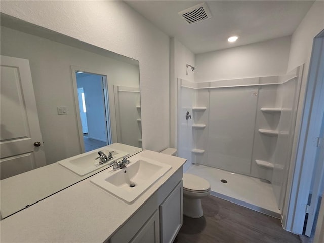 12519 Mountain Daisy Rd, Houston, TX 77038 - bathroom with wood finished floors, a shower stall, toilet, and vanity